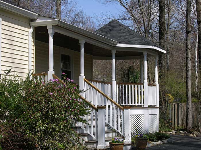 A dramatic porch adds visual interest and entertaining space to your home