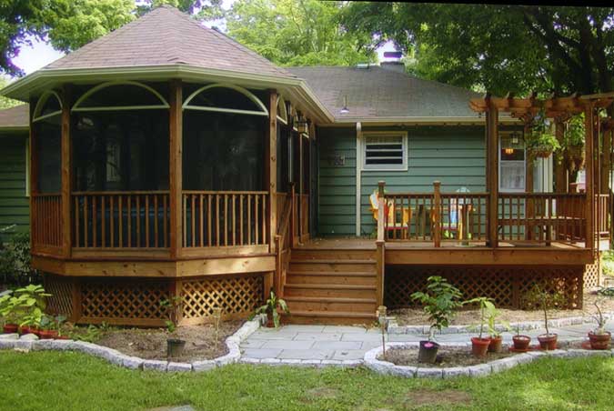 a deck and screened-in porch add excitement to rear of house