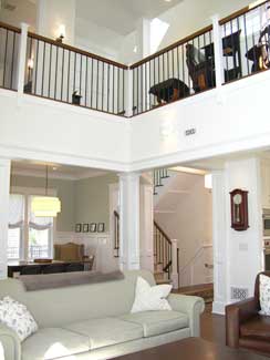 living room with dining room beyon and loft above