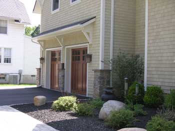 Craftsman detailing on doors doors lighting brackets stone piers