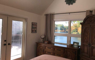 Master bedroom with newly vaulted ceilings and view out to the lake