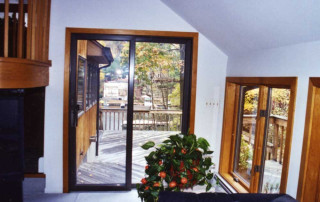 Living room windows frame a view of the lake beyond