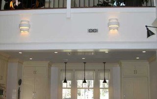Open floor plan between kitchen and living room with view up to the loft