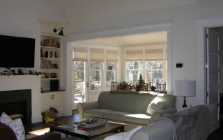 Open floor plan between living and dining rooms with access and view of the rear yard