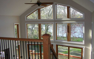 View from loft overlooking living room and wall of custom windows