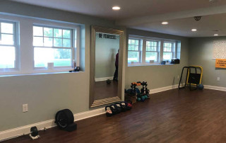 Yoga / Exercise Studio in basement with expansive windows to provide natural lighting