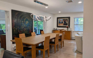 Dining area with glass pocket doors that open to the new sunroom