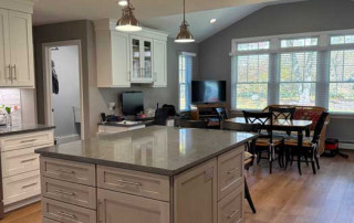 Kitchen open to dining area with view to backyard
