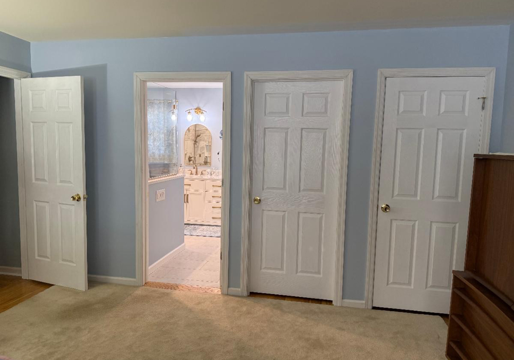 View from the bedroom into the new bathroom, new linen closet and master closet - after