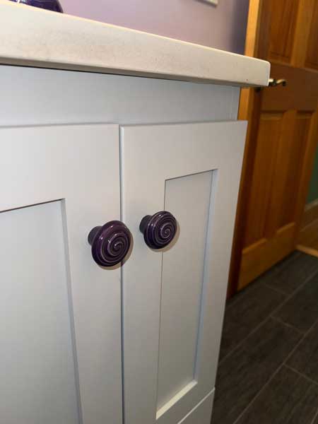 The search yielded swirly funky purple knobs for the vanity.
