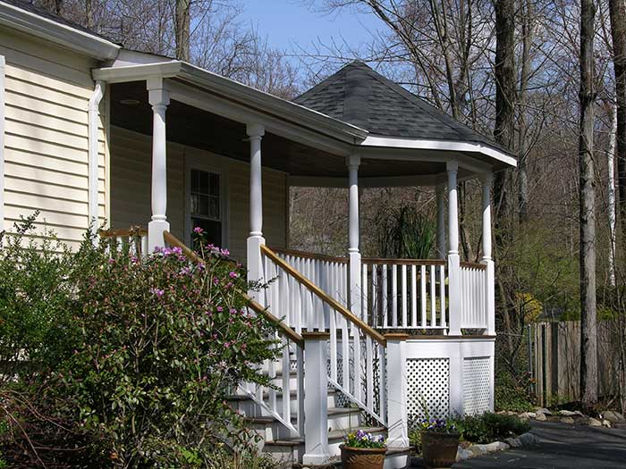 A dramatic porch adds visual interest and entertaining space to your home