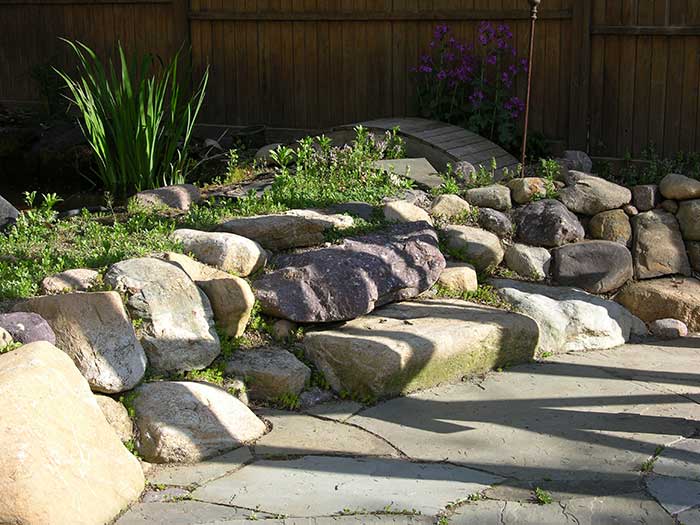 Terracing you lot with existing rocks can create useable level space