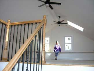 second floor is a spacious walk-up “attic” with large windows and a skylight